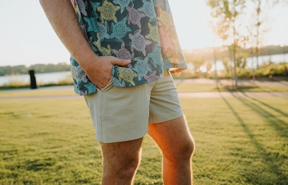 Rambler Rovers shorts in Khaki worn by a lake at golden hour